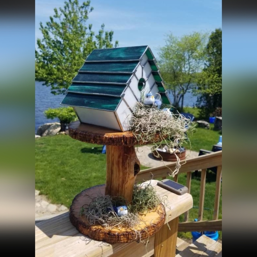 Handmade Stained Glass Light Birdhouse on wooden stand.
